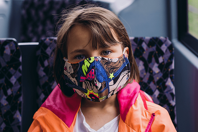 school aged child wearing colorful mask