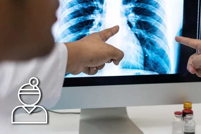 Doctor looking at chest x-ray on a computer screen.