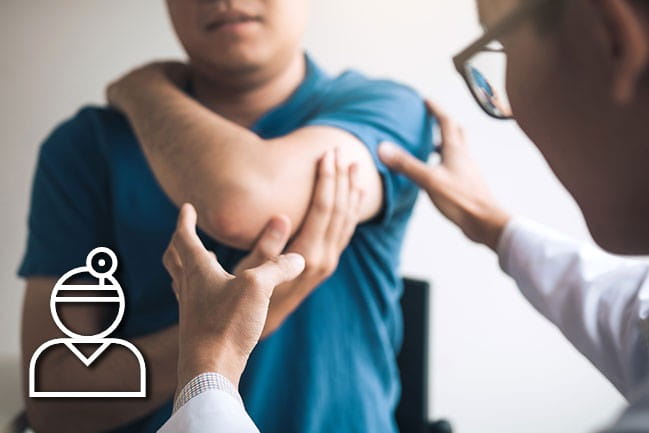 Provider examining patient elbow