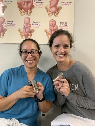 Doctors Megann Helton-Rieter and Lauren Brown with speculums 