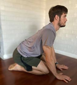 MUSC Physical Therapist Aaron Brown demonstrates a thoracic extension stretch called the short kneeling cat-cow.