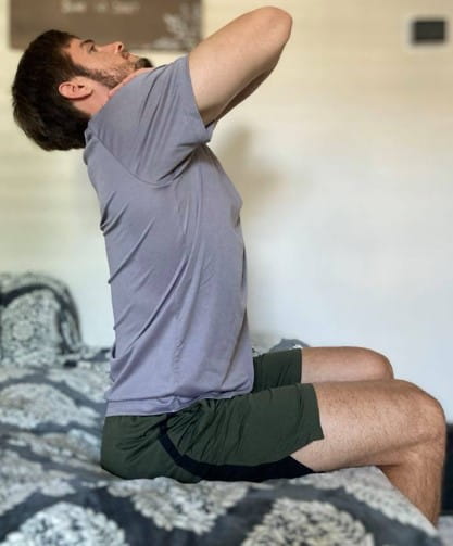 MUSC Physical Therapist Aaron Brown demonstrates a mid-back extension called a thoracic extension.