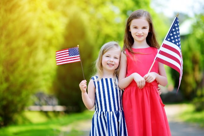 Two girls holding American flags.