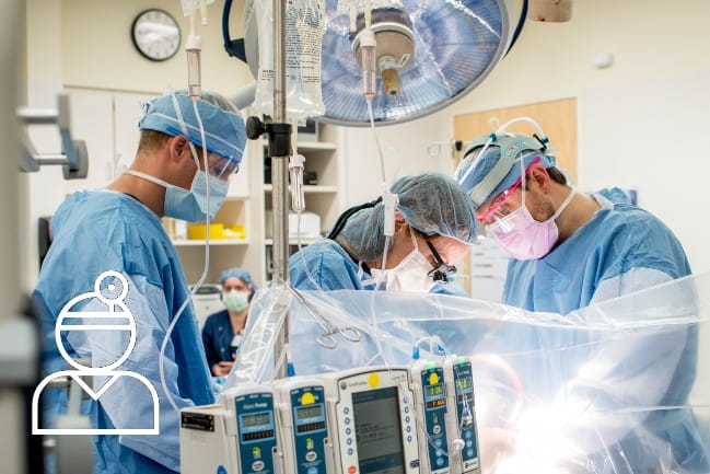 Three doctors in the OR performing surgery