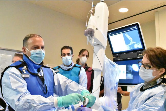 Dr. Hourany and other care team members performing robotic bronchoscopy. 