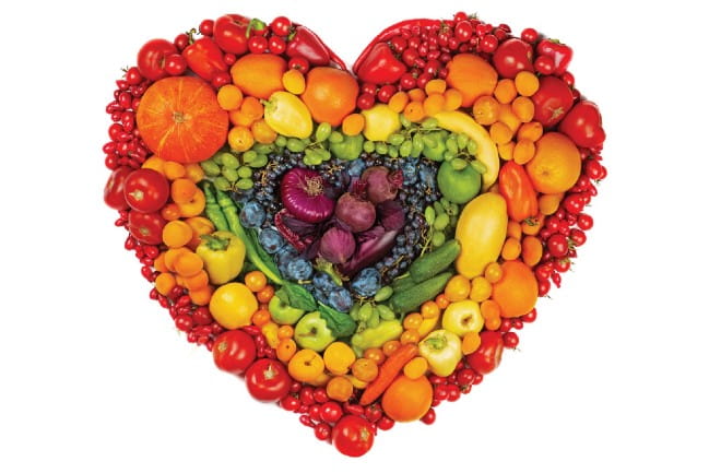Collage of a heart made out of vegetables