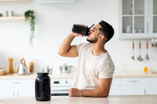 Person in kitchen drinking