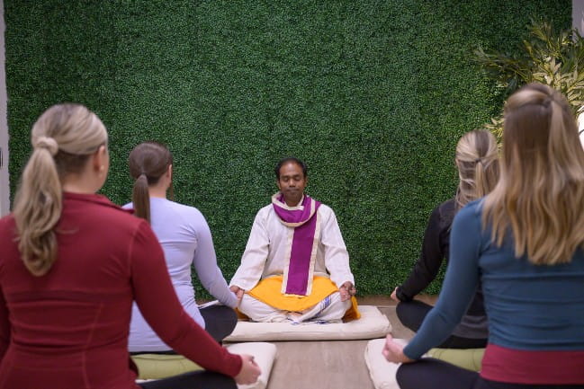 Group of people practicing yogic breathing.