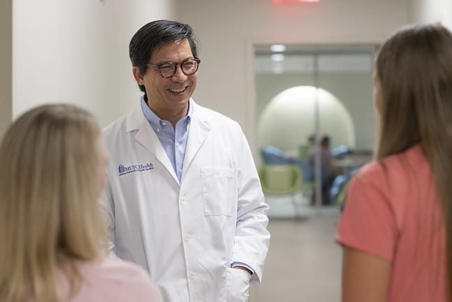 Dr. Chang speaks to other care team members