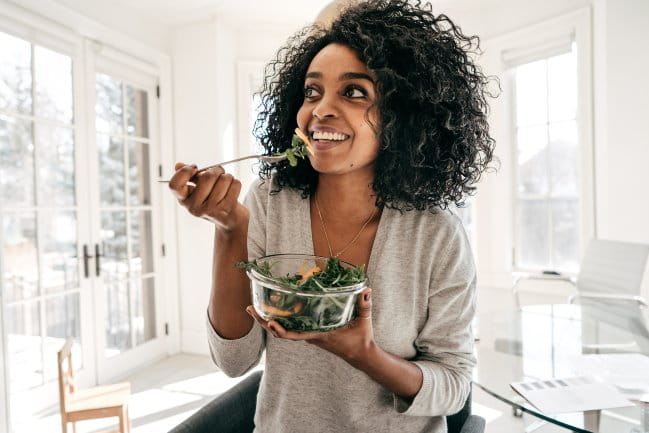 Woman eating a salad.