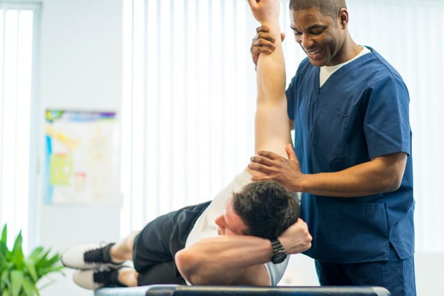 Physical therapist working with a patient.
