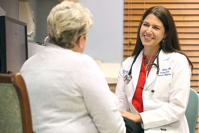 Dr. Erika Strand consults with a patient