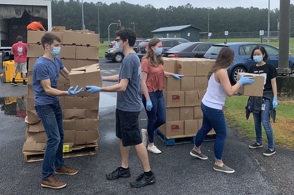 Medical students lift boxes.