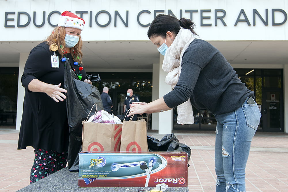 Program manager of volunteer services Kelly Hedges talks with Angel Tree donor Liz McPherson. Photos by Sarah Pack.